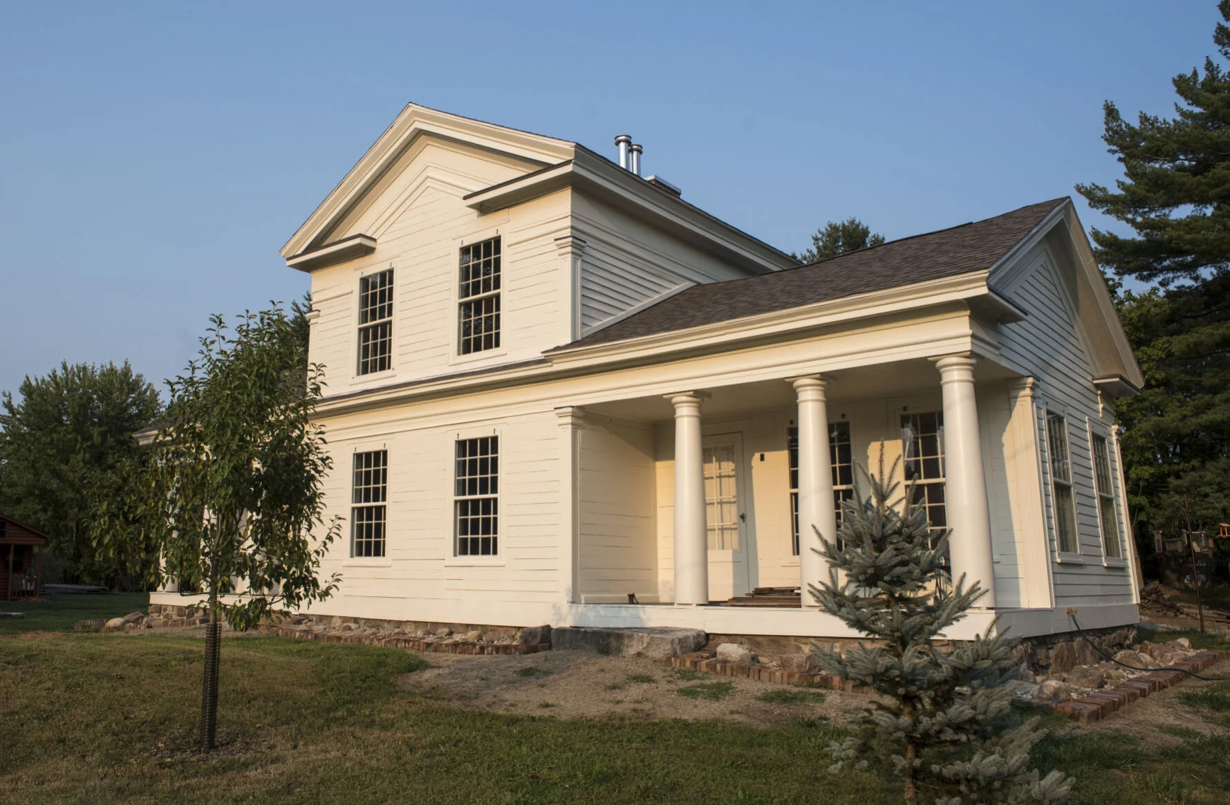 The Wolcott House in deteriorated condition before restoration, showing the aging Greek Revival structure along Wolcott Street