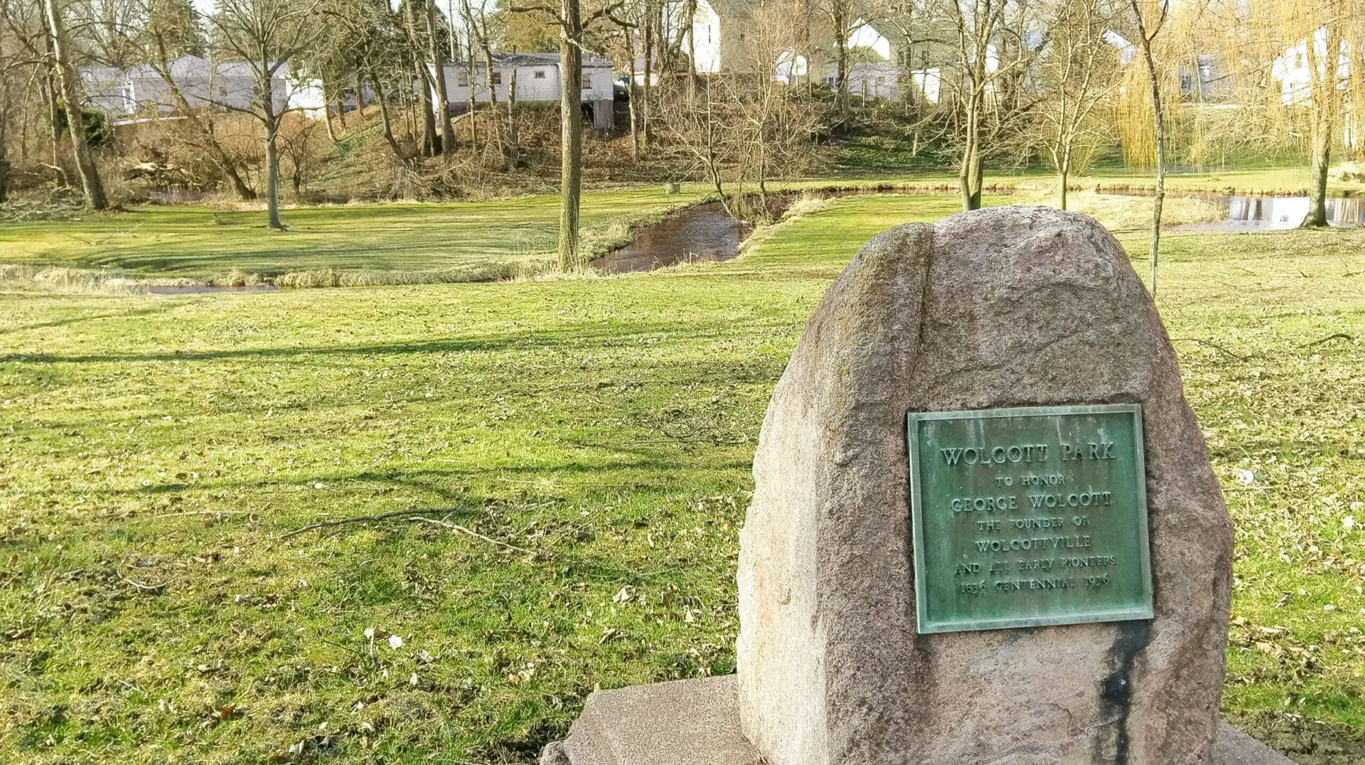 The commemorative stone marker at Wolcott Park honoring George Wolcott and the early pioneers of Wolcottville